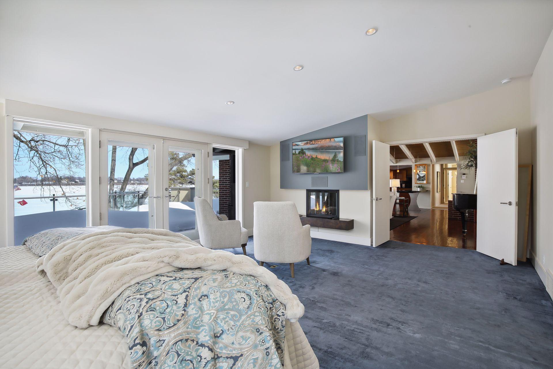 Main level owner's suite with access to the balcony and views of the lake beyond