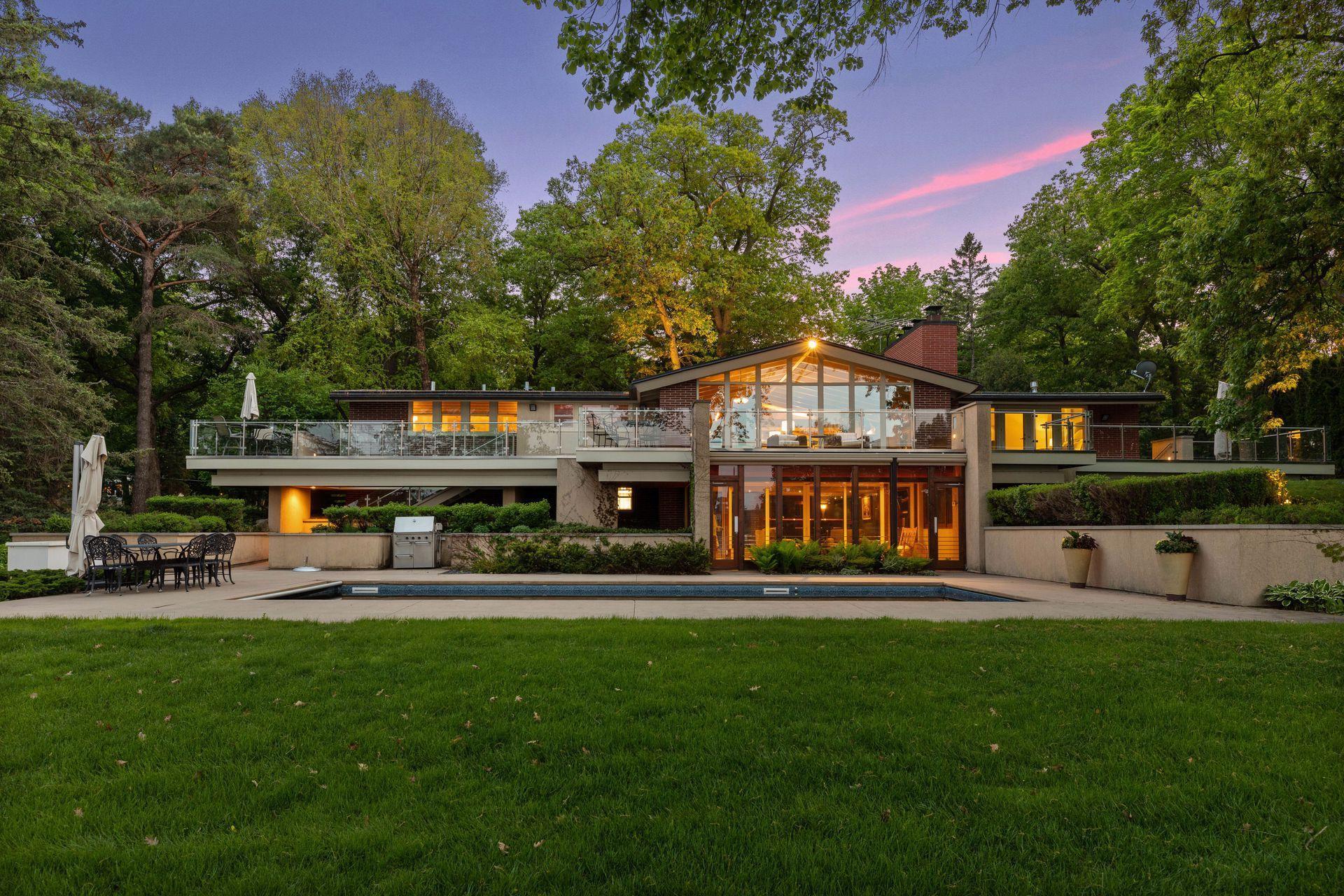 Twilight shot of the pool and back of home