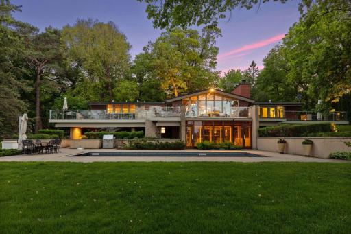 Twilight shot of the pool and back of home