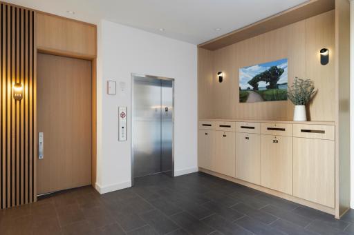 Lobby with custom mail and package cabinetry. Elevator runs to all 4 floors (Parking, 1st, 2nd, Rooftop)