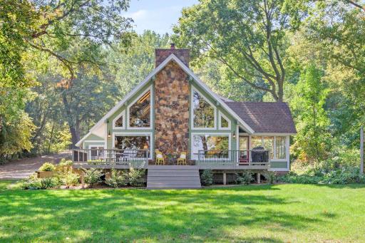Beautiful view of the main house, lakeside with great entertaining deck, newly stained and ready to go!