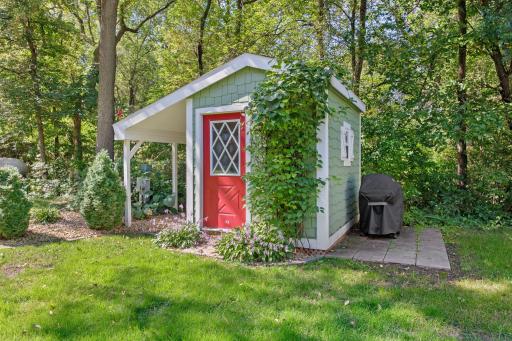 Yard game shed with grilling patio, conveniently located by the guest house.