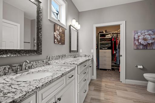 Primary private bath features a walk in closet and walk in shower