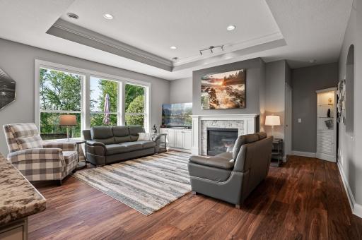 Open concept main floor flows into this beautiful living room with a cozy gas fireplace and tray vault ceiling.