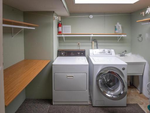 The finished laundry room has plenty of storage and a built-in folding table