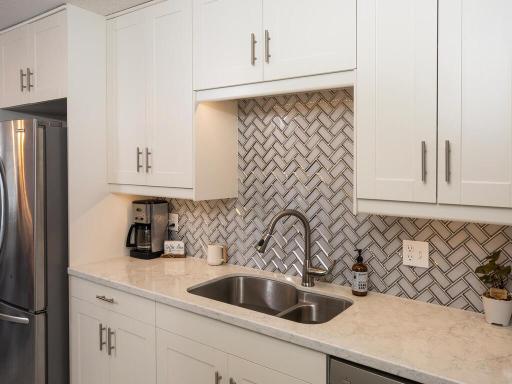 The custom back splash features a herring bone pattern with mirror beveled edge glass tile -- WOW!