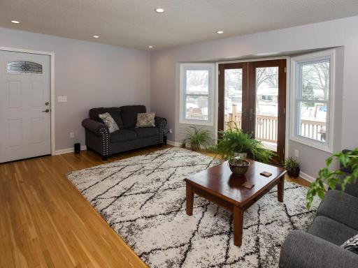 The living room features hardwood floors, canned lighting, and french doors that walk out to your spacious deck