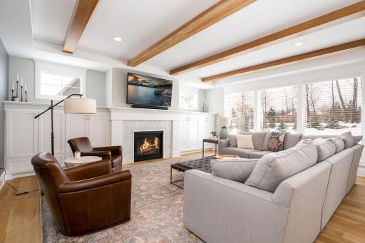 Formal main level living room. Wood beams, and large windows are warm and inviting