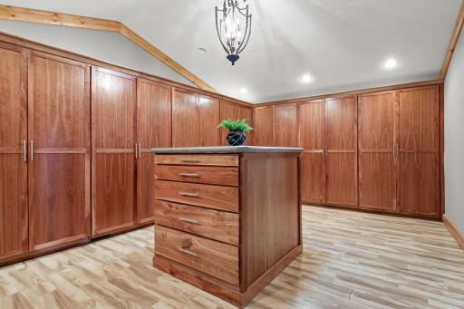 360 sq ft walk-in closet with floor to ceiling cabinets and center dresser.