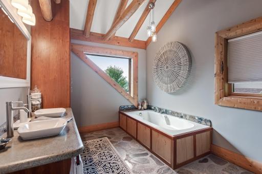 Luxurious bath with dual sinks, soaking tub and separate shower.