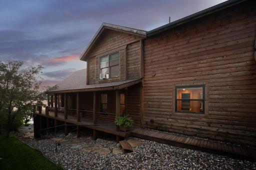 Stunning wrap around porch and stairs to backyard and the lake.
