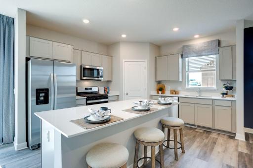 A kitchen built to perform - complete with an oversized island, pantry closet, stainless appliance package including a vented microhood and gas range, and enough space throughout for the family chef to roam about!