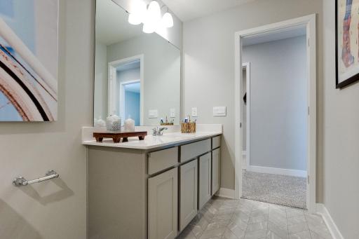 Each of those three upper level secondary bedrooms have access to this full bath, which is also features this huge, Quartz coated vanity! (Photo of model, colors may vary)