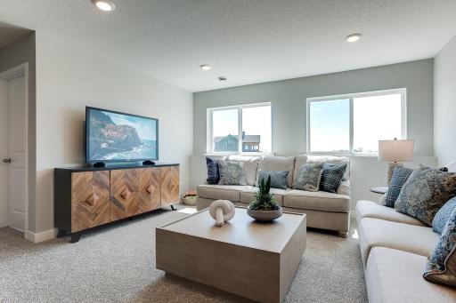 All of that living space up, PLUS this lower level family room - perfect for movie nights or catching the big game!!