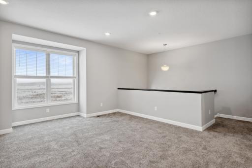 Entry from the front door to an open family room. Photos not of actual home. Actual home will be similar floorplan; some colors and features may vary.