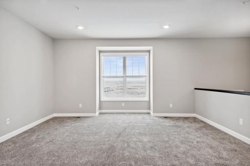 Main level family room. Photos not of actual home. Actual home will be similar floorplan; some colors and features may vary.