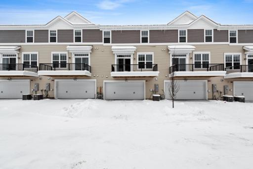 Back entry to the home with a large 2 car garage. Photos not of actual home. Actual home will be similar floorplan; some colors and features may vary.