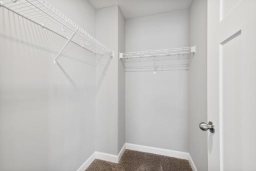 Owner's bedroom with a 2nd walk-in closet. Photos not of actual home. Actual home will be similar floorplan; some colors and features may vary.