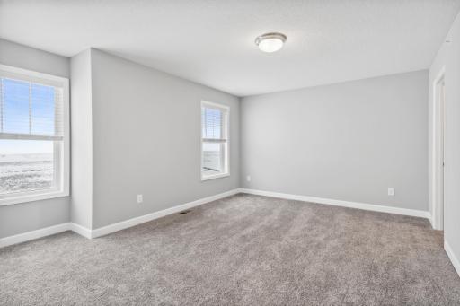 Spacious owner's suite with private bath. Photos not of actual home. Actual home will be similar floorplan; some colors and features may vary.