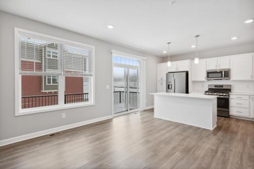 Convenient sliding glass door to a private deck to grill or enjoy your outdoor space. Photos not of actual home. Actual home will be similar floorplan; some colors and features may vary.