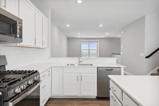 Open concept floorplan with a spacious kithen and family room. Photos not of actual home. Actual home will be similar floorplan; some colors and features may vary.