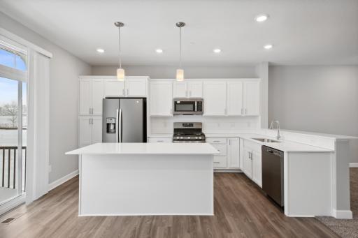 Plenty of cabinets and storage in the kitchen. Photos not of actual home. Actual home will be similar floorplan; some colors and features may vary.