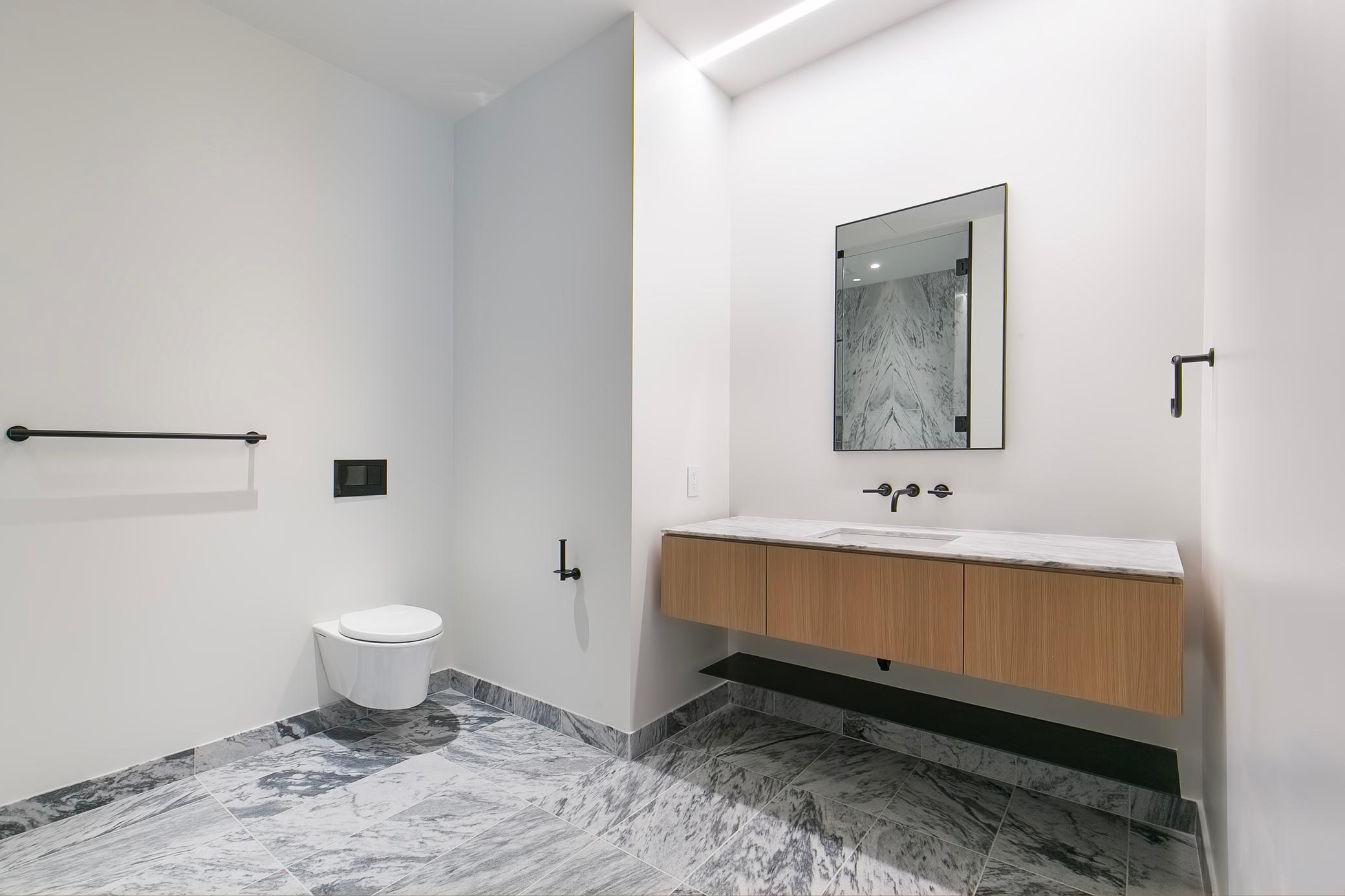 Bathroom with heated marble flooring and stunning walk-in shower stall.