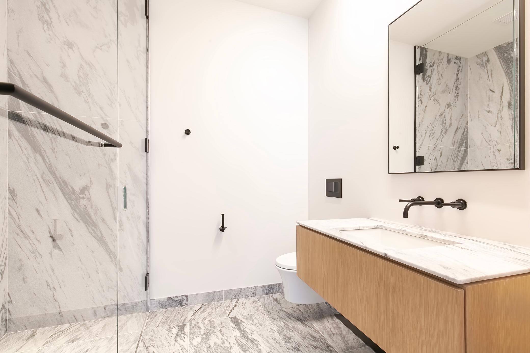 Another bathroom with heated marble flooring and stunning walk-in shower stall.