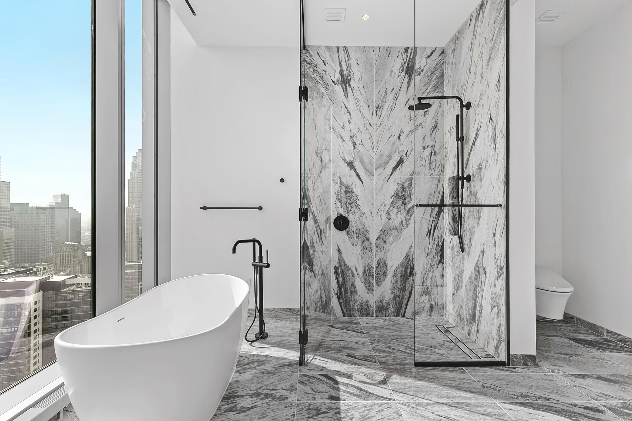 Captivating views, freestanding bathroom tub with tub filler, motorized shades. Lavish primary, private bathroom with stunning marble walls and heated flooring