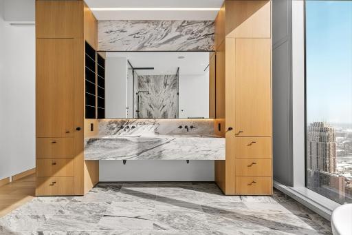 Lavish primary, private bathroom with stunning marble walls and heated flooring