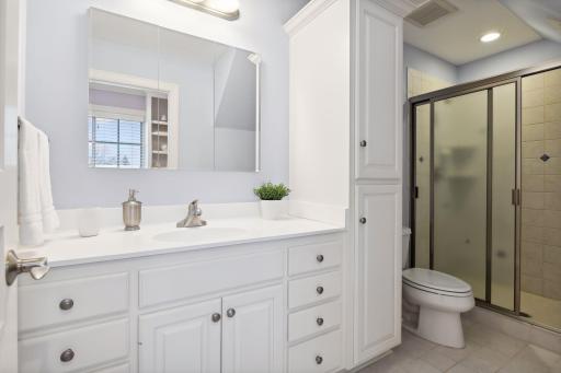 Ensuite bath includes vanity, custom storage and shower