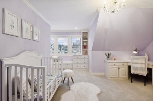 Bedroom #2 with extensive built-ins including window seat with storage, desk and walk in closet