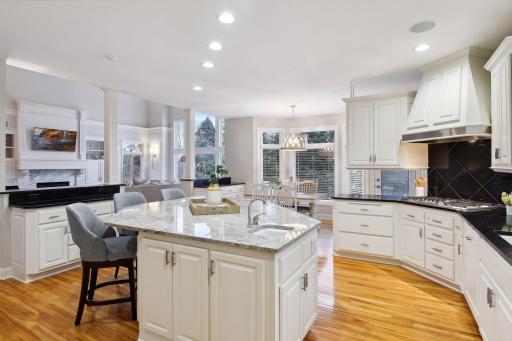 Large center island, custom cabinetry and buffet counters enhance the flexibility for dining and entertaining for family and friends