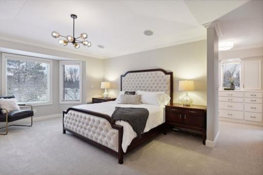 Primary bedroom suite with built-ins, gas fireplace and a walk-in closet