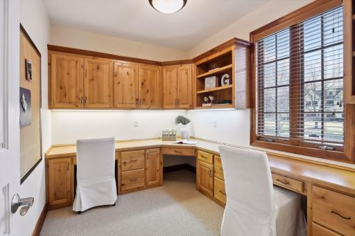 Resource room off the kitchen for home work or projects is next to the mudroom and family powder room. There is an additional main floor powder room off the foyer for guests