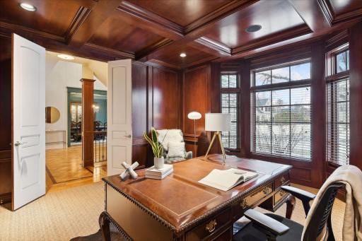Windows with blinds provide a view of the large front yard and streetscape