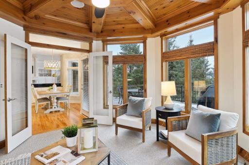 Sunroom overlooks the deck and backyard fire pit