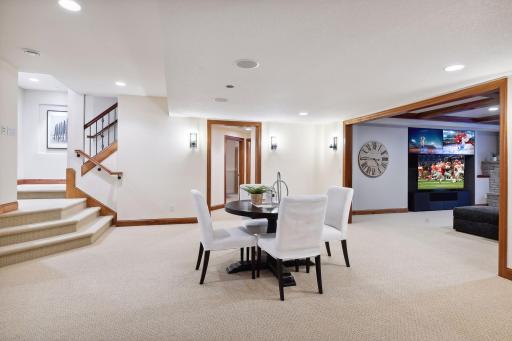 Enter the lower level from the foyer near the front entrance. There is a second staircase from the garage allowing access to the main level without entering the main house.