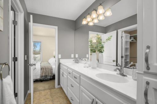 Primary bathroom with 2 vanity sinks and a walk in shower