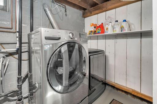 Clean laundry space! Window above utility sink