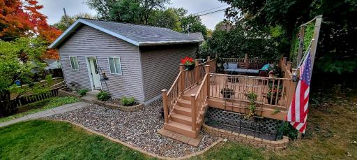 Enjoy the outdoors on the maintenance free deck + a 2-car detached garage with 8’ garage doors, attic storage and workspace - excellent for Minnesota winters!