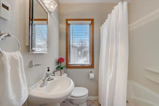Only steps away is the full shared bathroom which includes heated tile floors, a jetted tub and laundry chute.