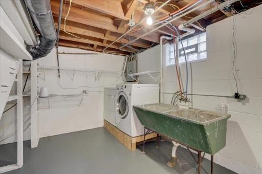 Also on the lower level is the large unfinished utility room which doubles as the laundry room with utility sink and ample storage!