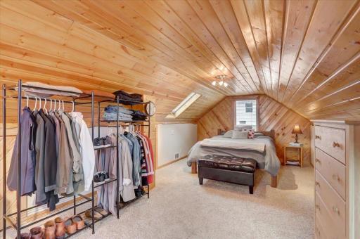 Enormous upper level primary bedroom with a gorgeous tongue-and-groove ceiling, skylights, and built in storage nooks.