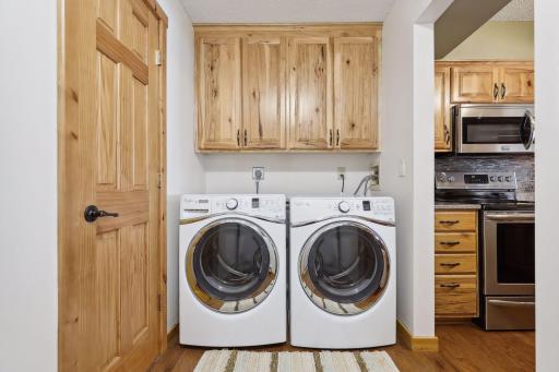 5 x 13 laundry room with whirlpool appliances and hickory cabinets. Laundry room also includes a second refrigerator and additional storage, not pictured.