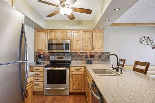 Newer stainless-steel appliances, double sink, recessed lighting, under-cabinet lighting and new ceiling fan, highlight the kitchen