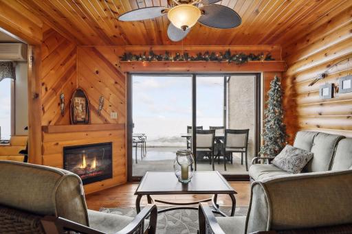Enjoy the lake views from the comfort of your sunroom with lovely pine walls and fireplace, providing a warm and cozy cabin-like feel