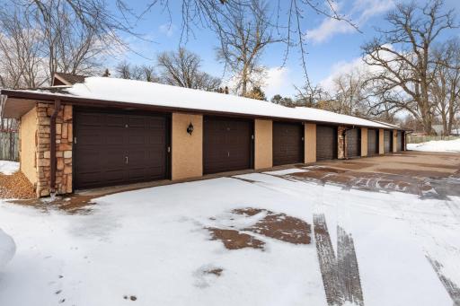 Single car garage, third from the left, included with purchase, plus one reserved spot in parking lot. Outdoor boat storage available behind garage.
