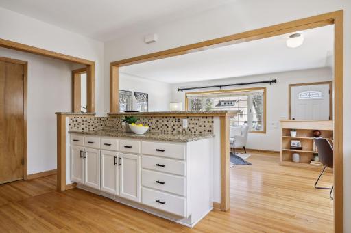 Granite countertops and white kitchen cabinetry.