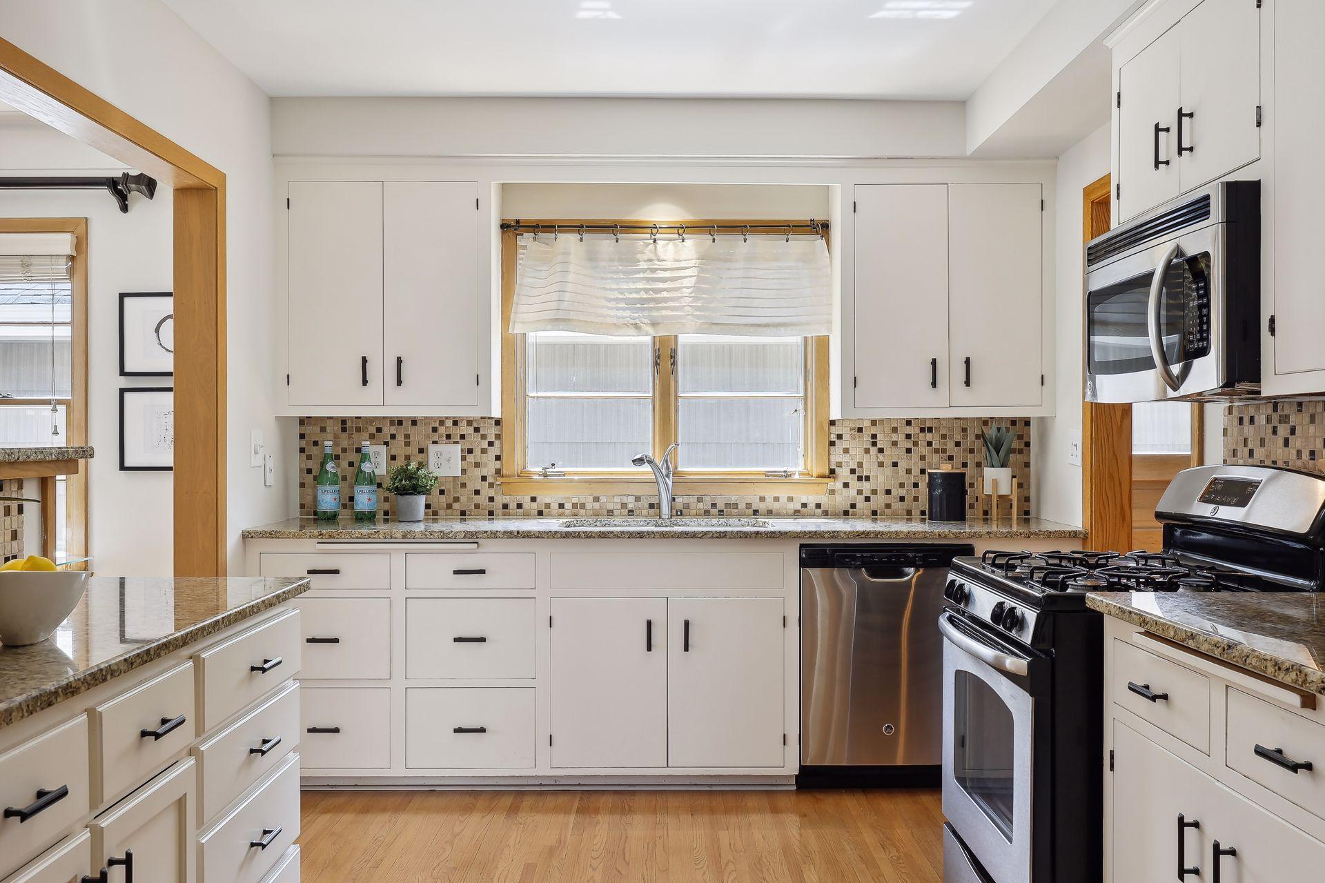 Spacious kitchen with tile backsplash.